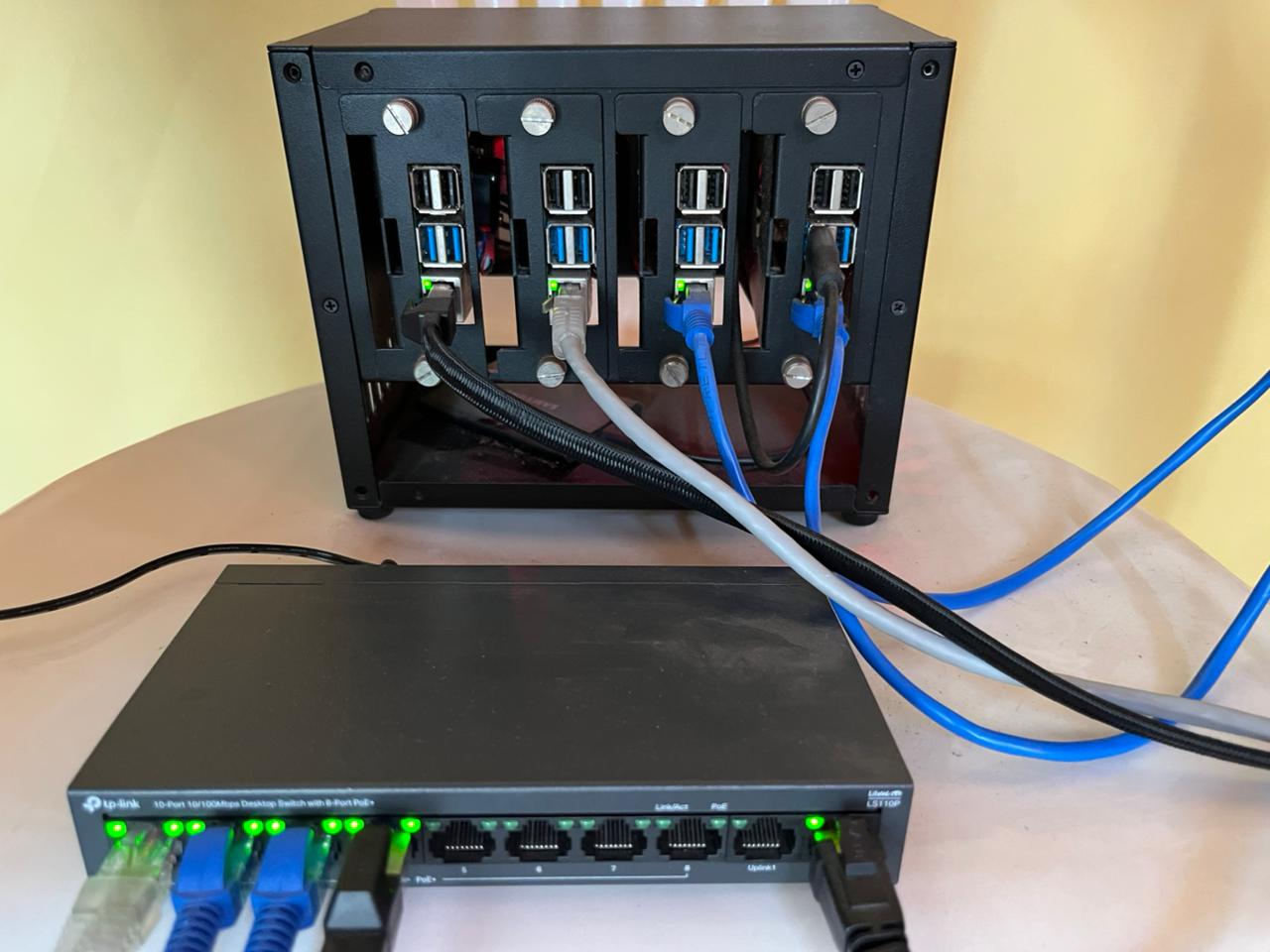 4× Raspberry Pi 4 in a rack enclosure connected to a TP-Link PoE switch